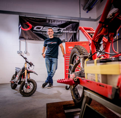Dan Hicks in a workshop with an electric trial bike
